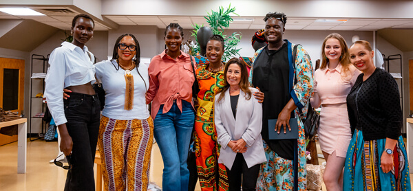A diverse group of women standing together in a room, showcasing unity, empowerment, and camaraderie