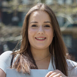 Headshot of Taylor Peel with a book in her hands 