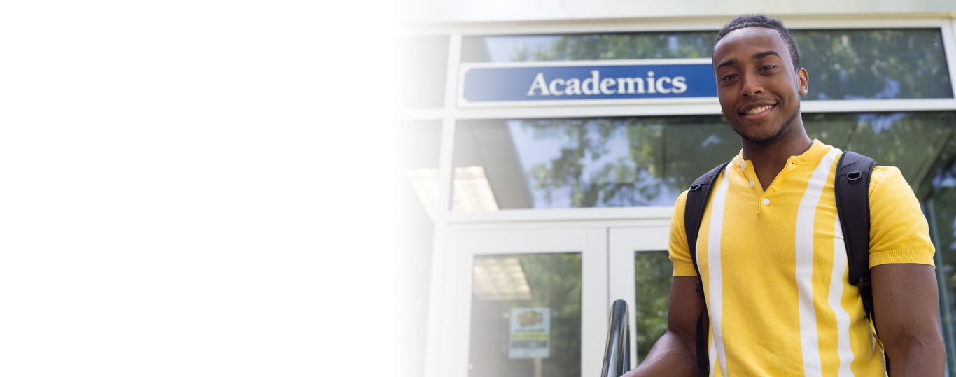 Photo of Berkeley College student in front of Academics building at the Woodland Park campus.