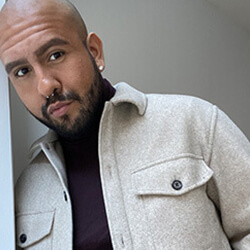 Picture of Alejandro Guillen leaning on a wall