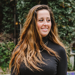 Ane Wangen wearing a black top, standing against a neutral background
