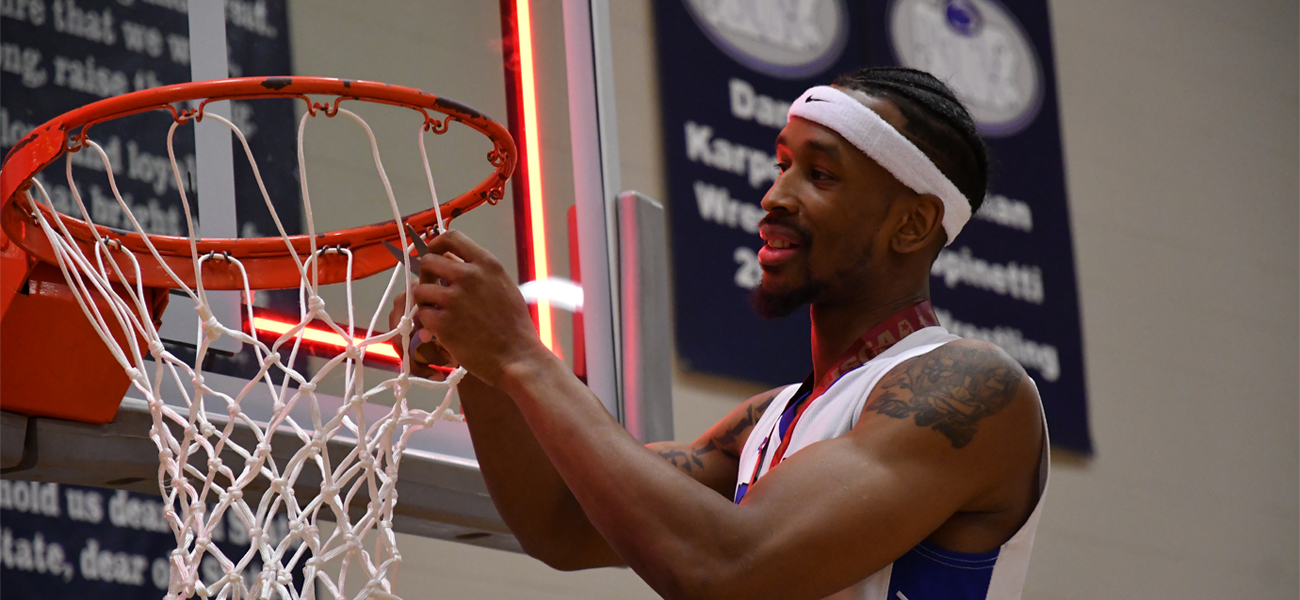 Berkeley Knights player cutting Basketball net