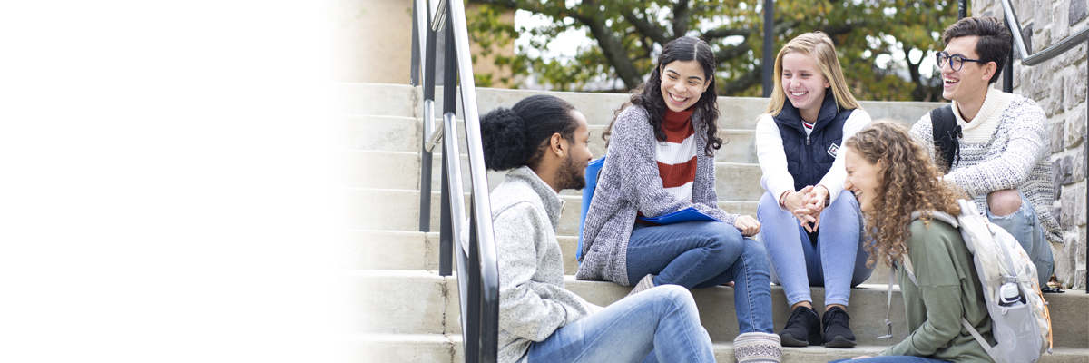 Group of students sitting on stairs at the Woodland Park Campus