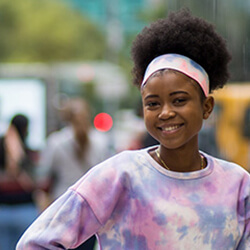 Duanakay Commock wearing a colorful tie-dye sweatshirt