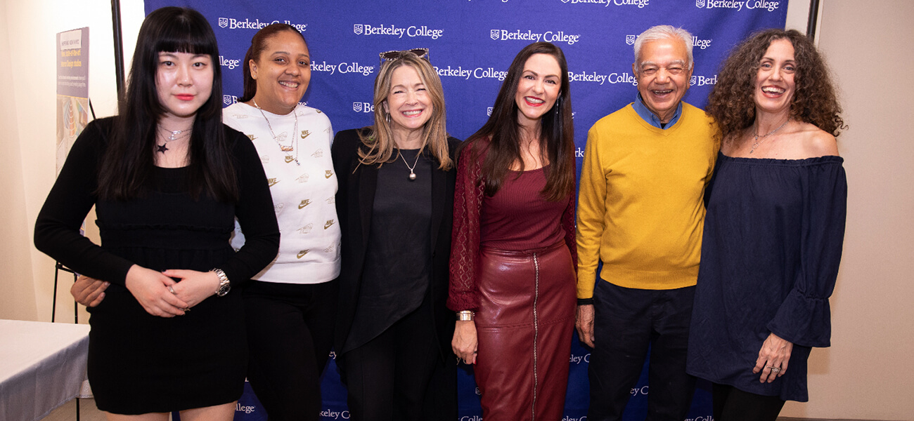 A diverse group of people smiling and posing together for a photo at a lively event