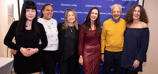A diverse group of people smiling and posing together for a photo at a lively event