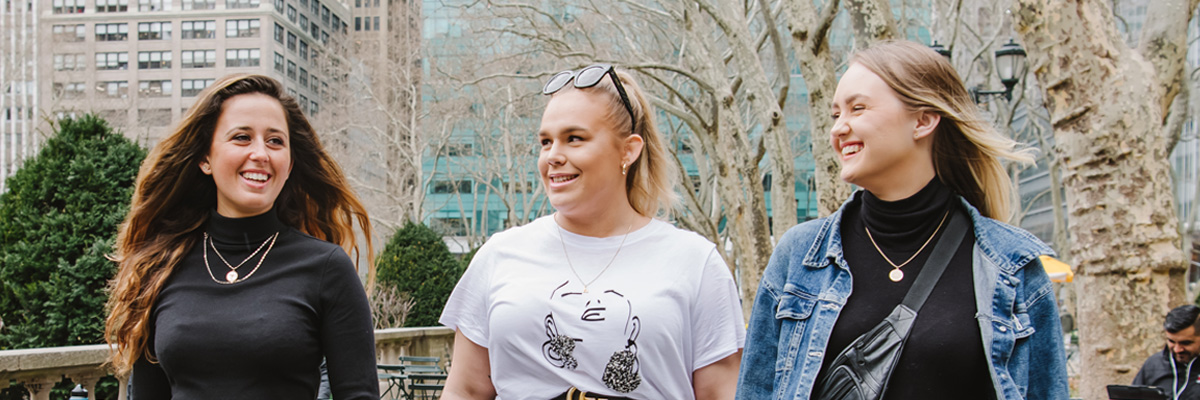 3 female students walking in Bryant Park