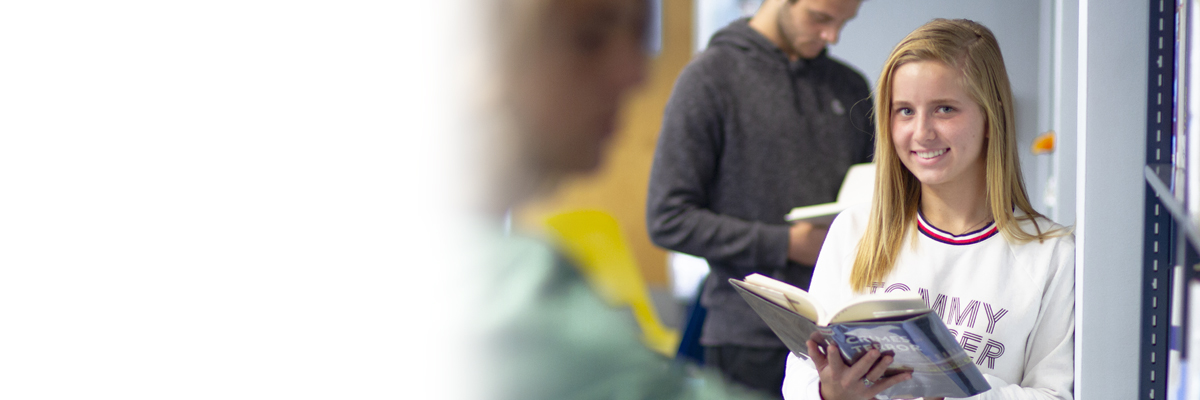 Female student with book in the library