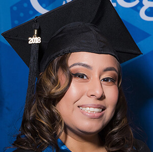 Headshot of Jennifer Ruesta wearing a graduation cap and gown