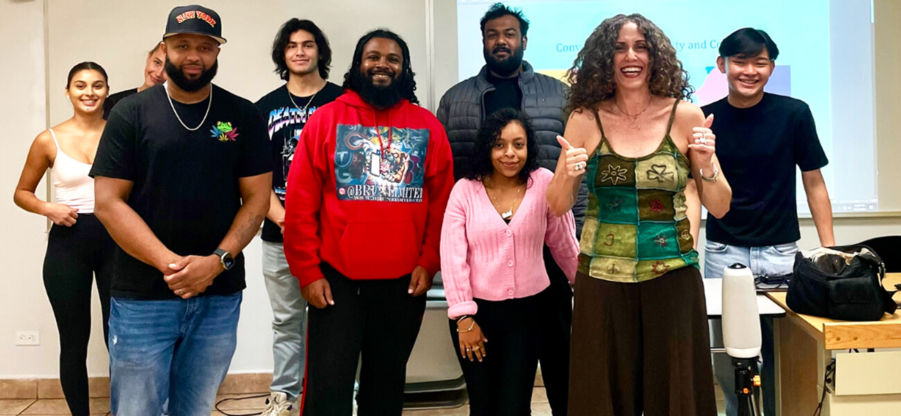 A diverse group of individuals gathered in front of a whiteboard, engaged in collaboration
