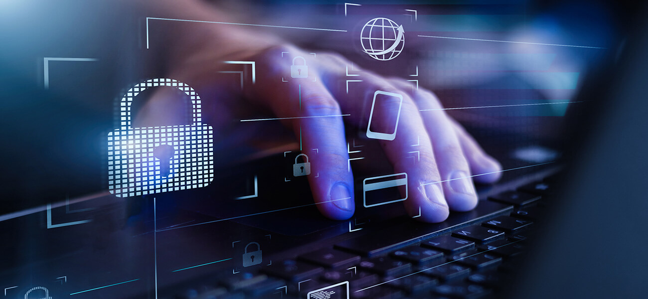 image of a person's hand with a computer keyboard and computer icos, locks, cellphones and credit cards around