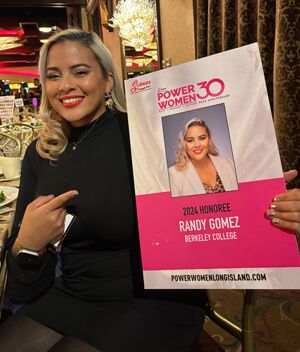 A woman proudly displays a sign reading "Power Woman 30," symbolizing strength and empowerment