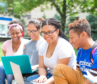 Image for mobile devices: Photo of Berkeley College students on a laptop outdoors.