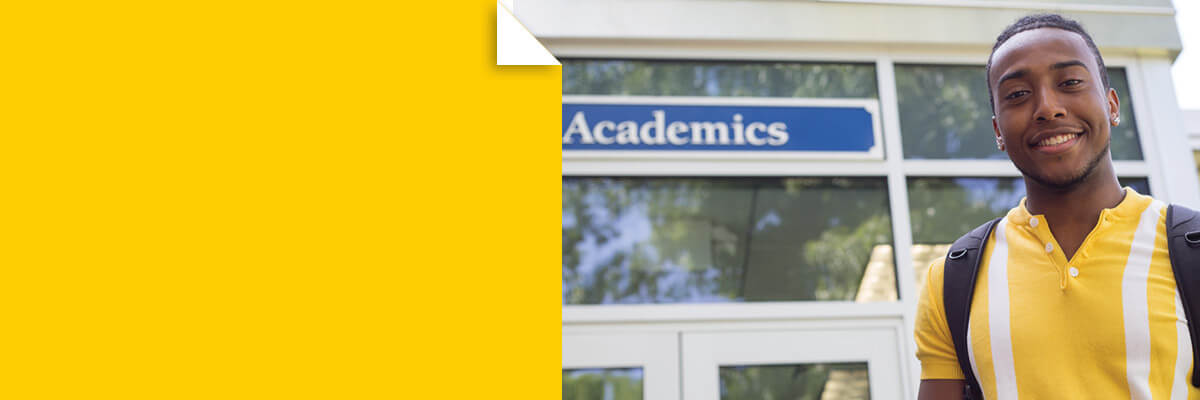 Photo of Berkeley College student in front of Academics building at the Woodland Park campus.