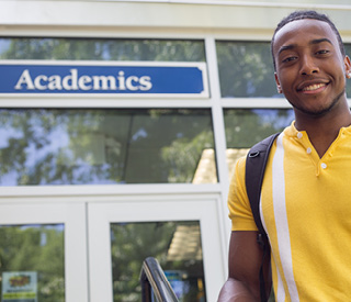Photo of Berkeley College student in front of Academics building at the Woodland Park campus. mobile image