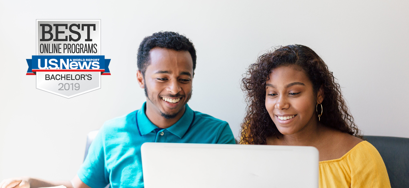 Male and female student looking at banner with US News and World Report Best Colleges for Online Bachelor’s Degree Programs badge