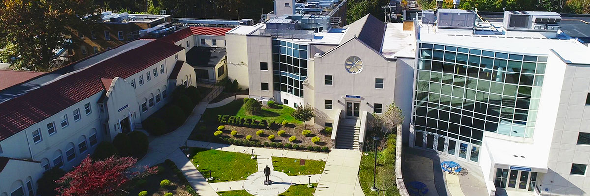 Image: Photo of the 3 Berkeley College at Woodland Park Campus sitting on a bench under a tree