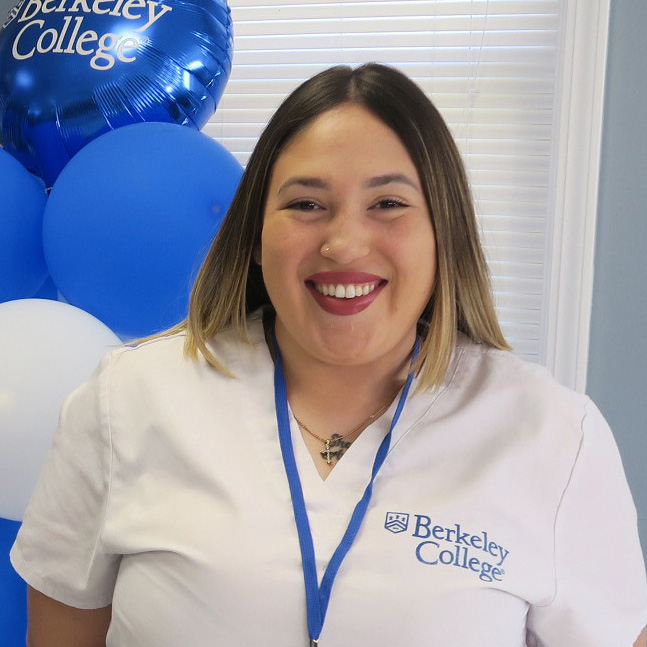Berkeley nursing graduate Breanna Beauchamp wears her white scrubs