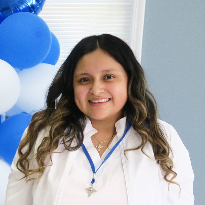 Berkeley nursing graduate Jessica Carchi wears her nursing white scrubs