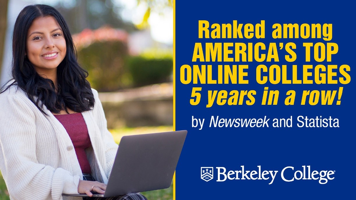 A girl smiles and works on a laptop.