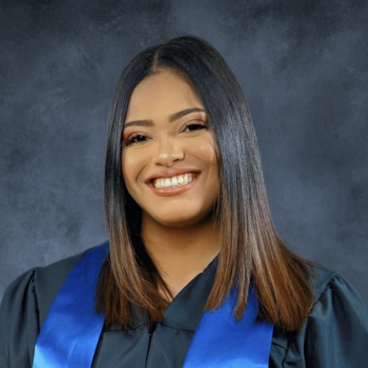 Berkeley graduate Sandybel Reynoso Garcia poses in cap and gown regalia
