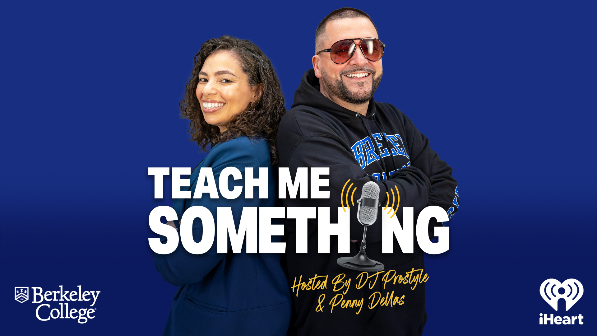 A man and a woman stand back to back with arms folded