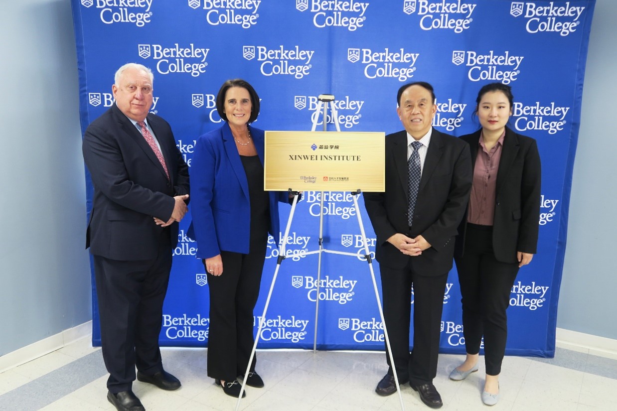 Berkeley College officials stand in front of the Xinwei plaque