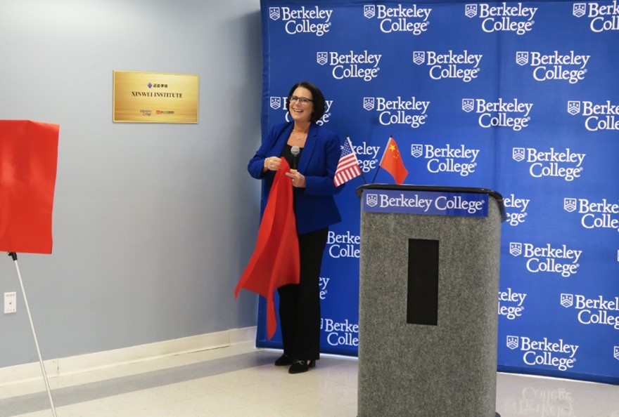 President Diane Recinos unveils the plaque for Xinwei Institute
