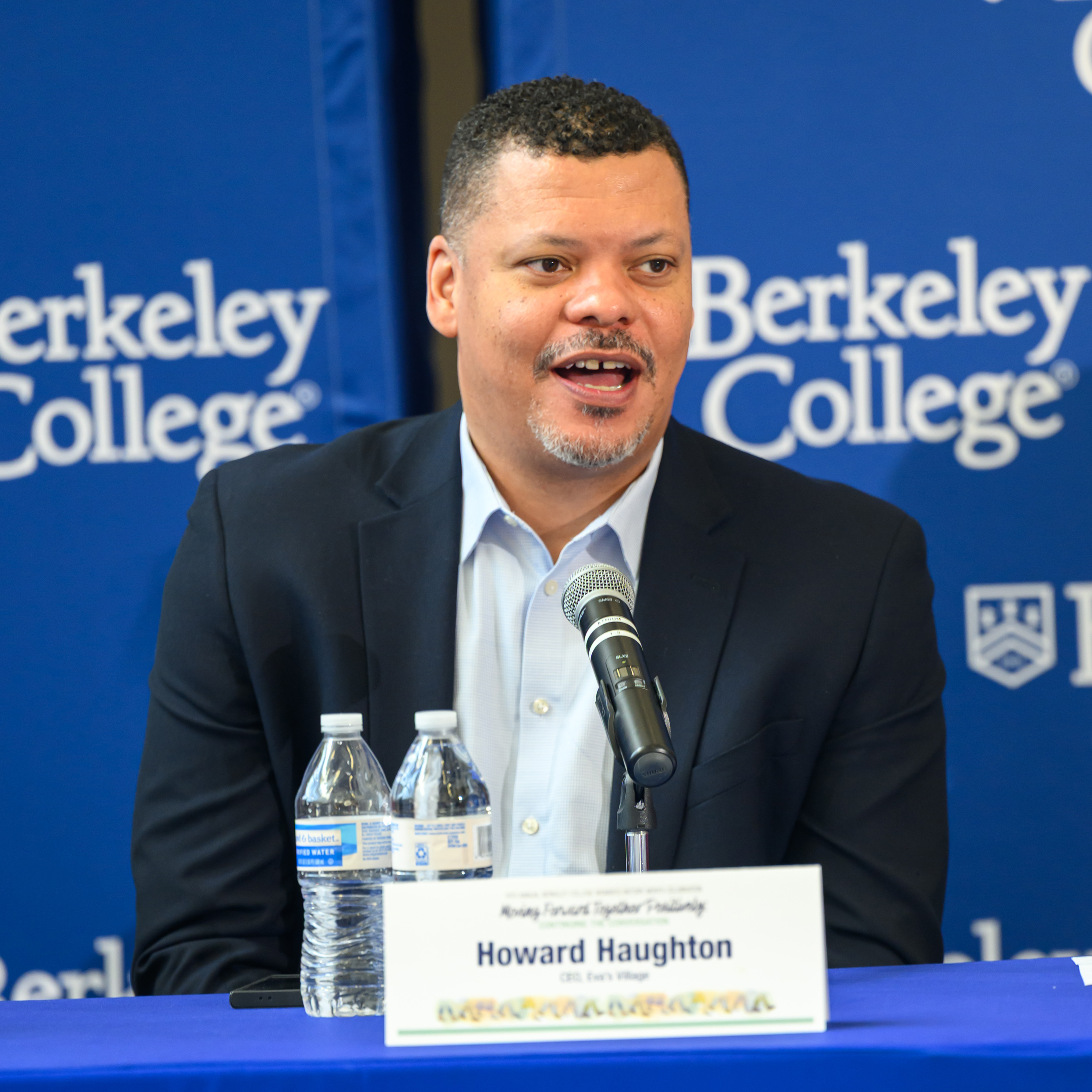 A man in a suit speaks