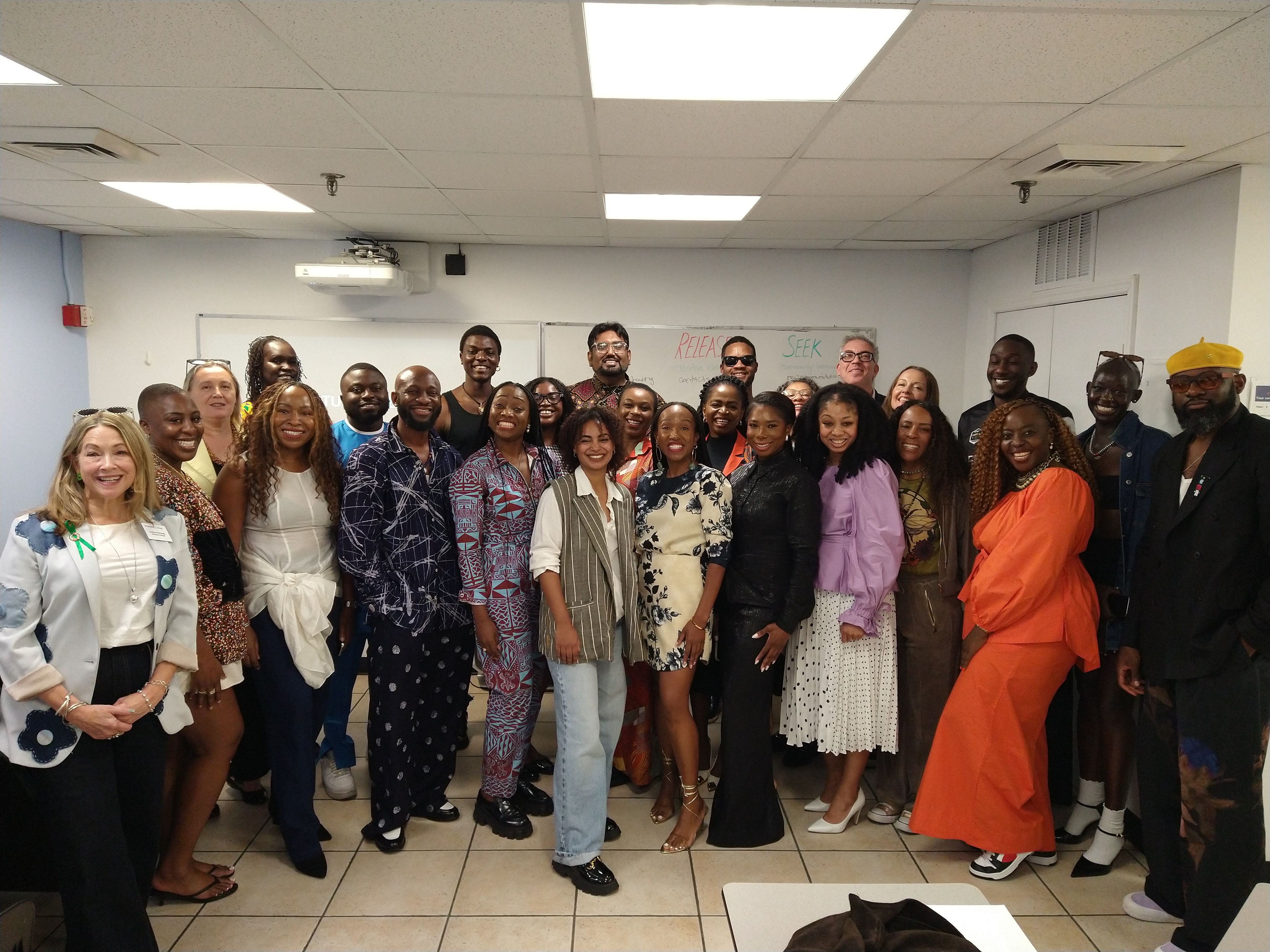 A group of people smile and pose for a photo