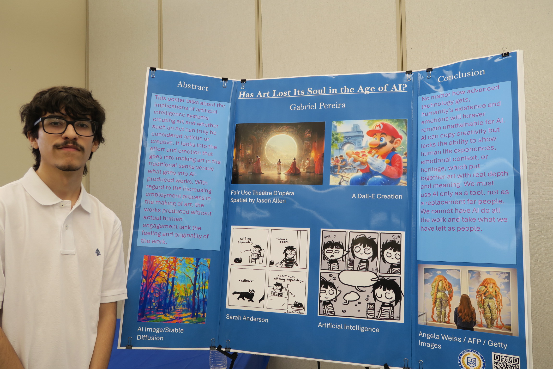 A young man stands next to his research poster
