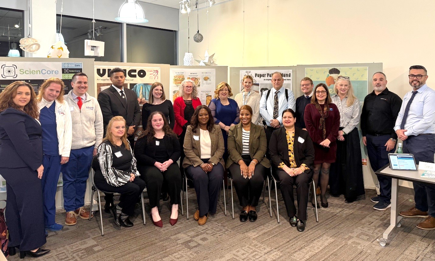 A group of diverse people smile and pose for the camera.